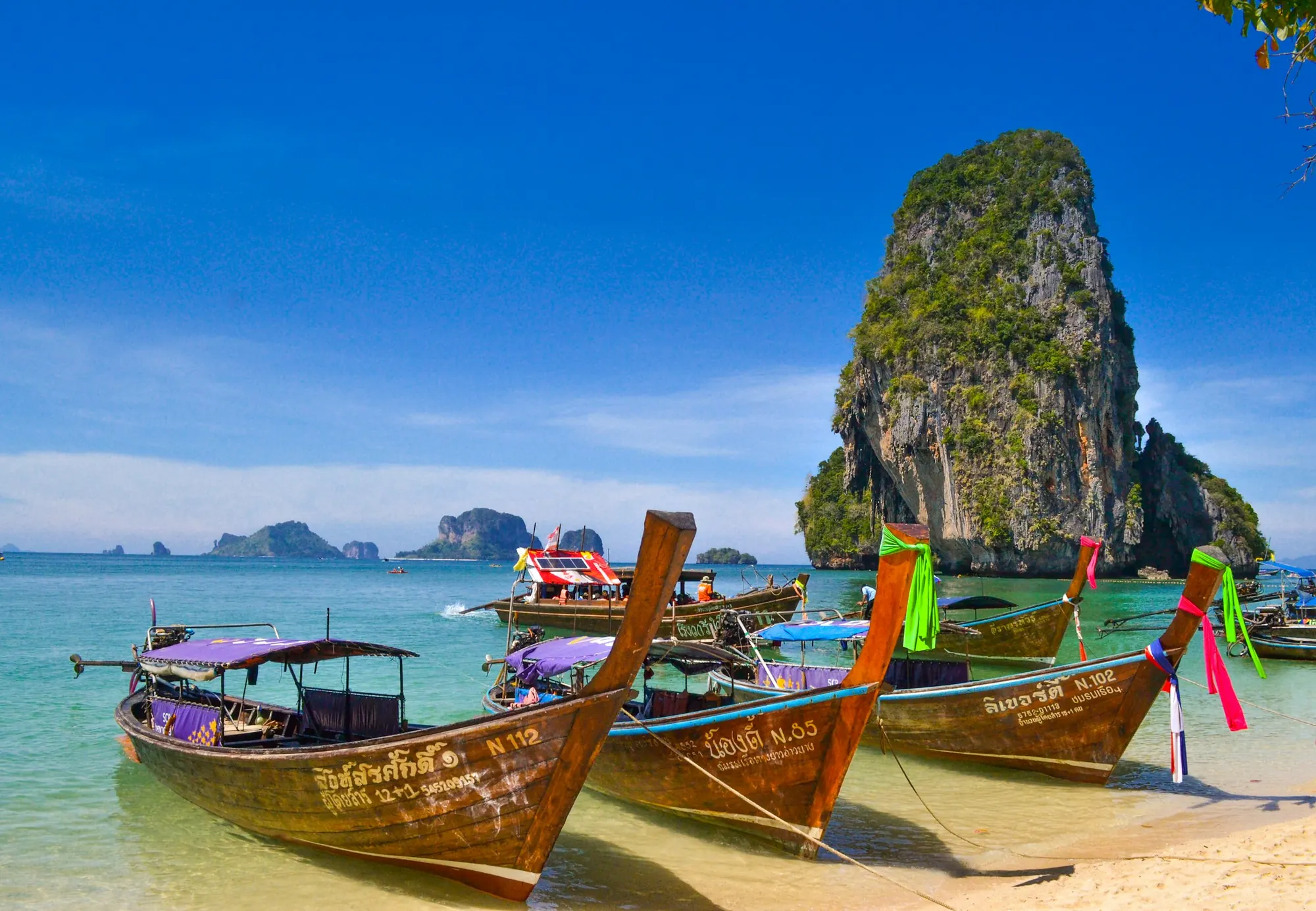 Longtail boats and limestone cliffs at Railay Beach, Thailand
